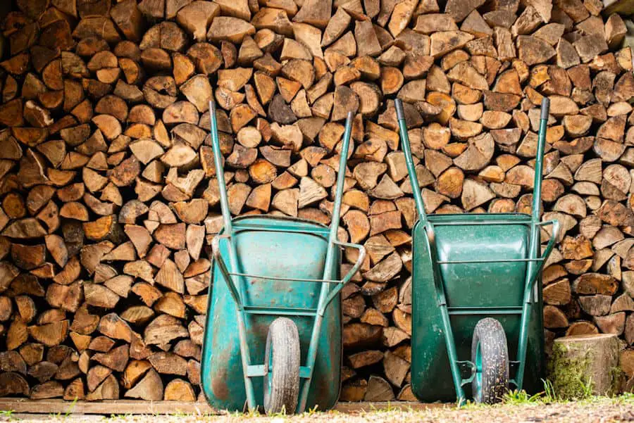 how many wheelbarrows in a cord of wood - two wheelbarrows in front of a stack of firewood