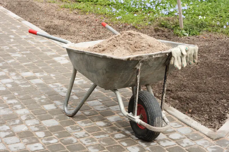 A picture of a wheelbarrow full of sand - How Much Sand Does A Wheelbarrow Hold (How Much Does It Weigh)